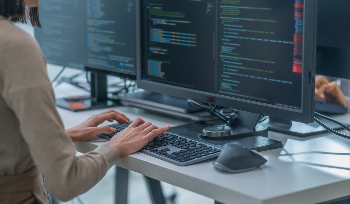 Programmer coding at a desk setup
